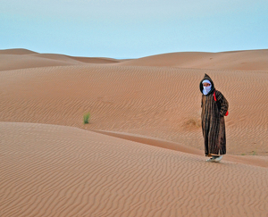 Djellaba Clad Moroccan Man in the Sahara - Photo by Louis Arthur Norton