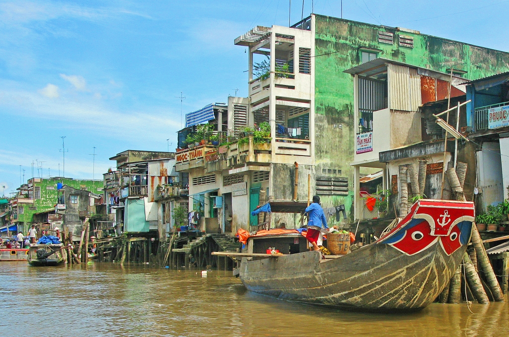 Busy Mekong Riverfront by Lou Norton
