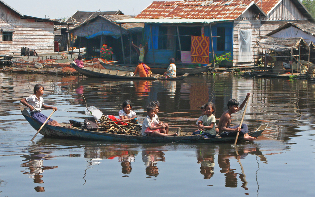 Cambodian Lake-children Paddle To School by Lou Norton