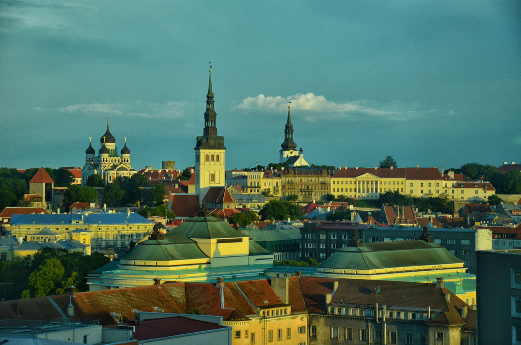 Dawnn Reflected Off The Tallinn Estonia Roof Tops by Lou Norton