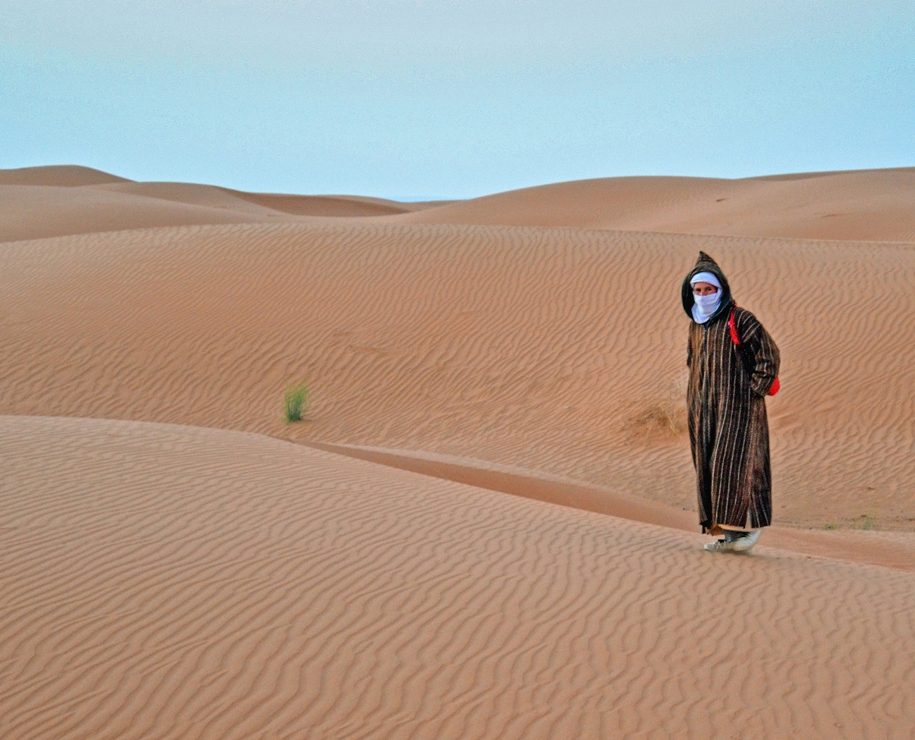 Djellaba Clad Moroccan Man in the Sahara by Lou Norton