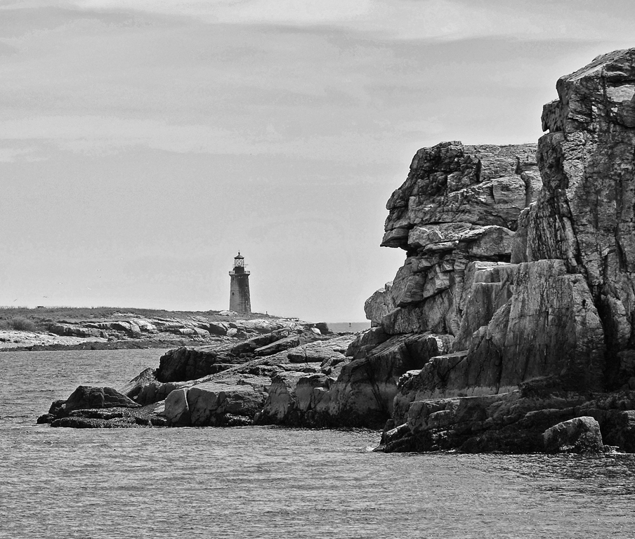 Granite Indian Head And Lighthouse In Maine's Casco Bay by Lou Norton