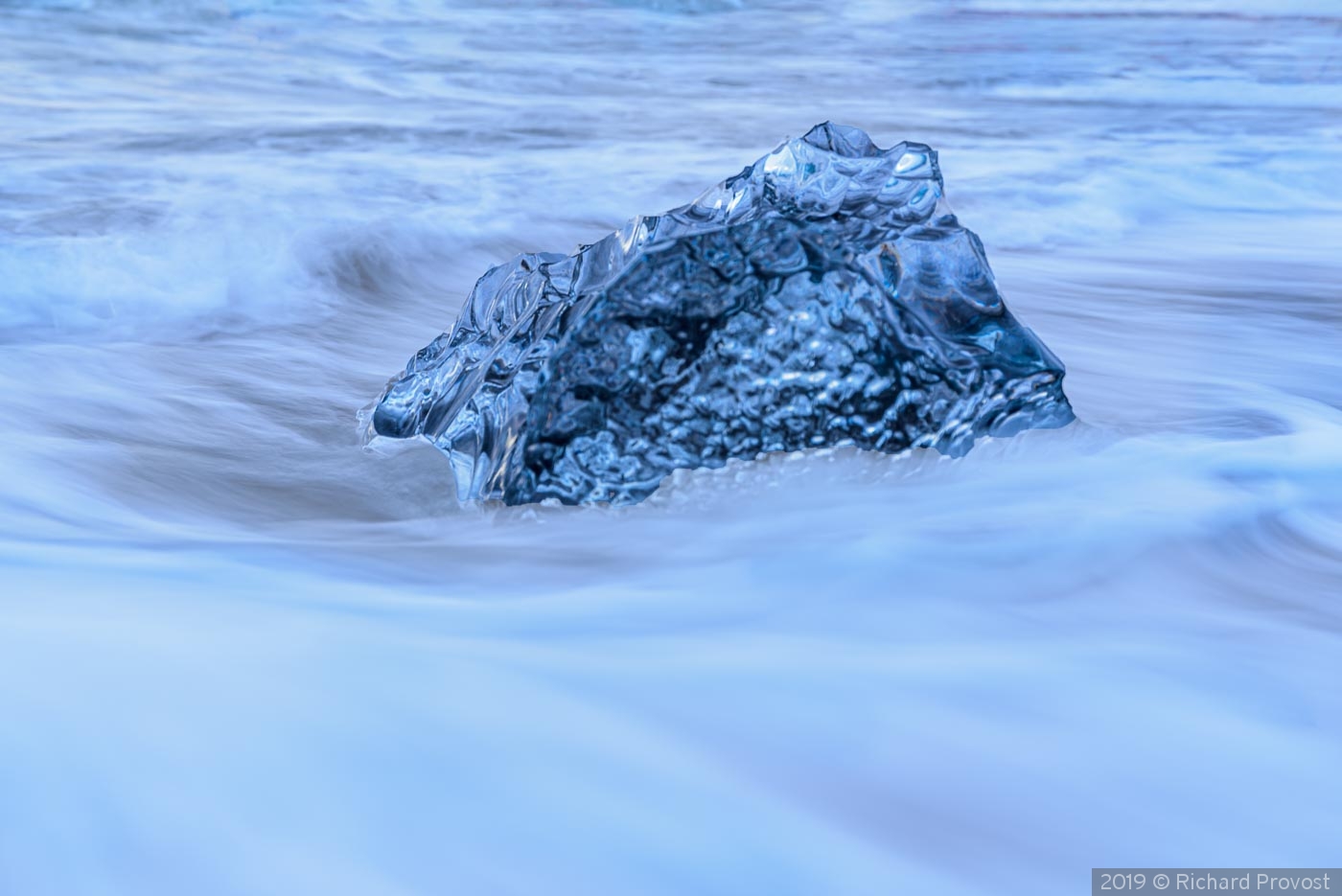 Ice in swirling water by Richard Provost