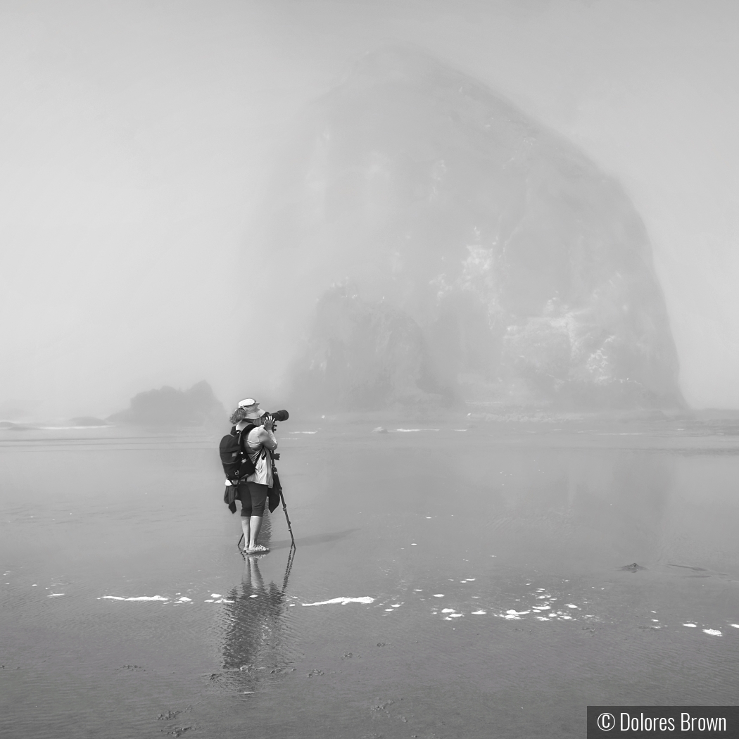 Photographer on a Foggy Cannon Beach by Dolores Brown