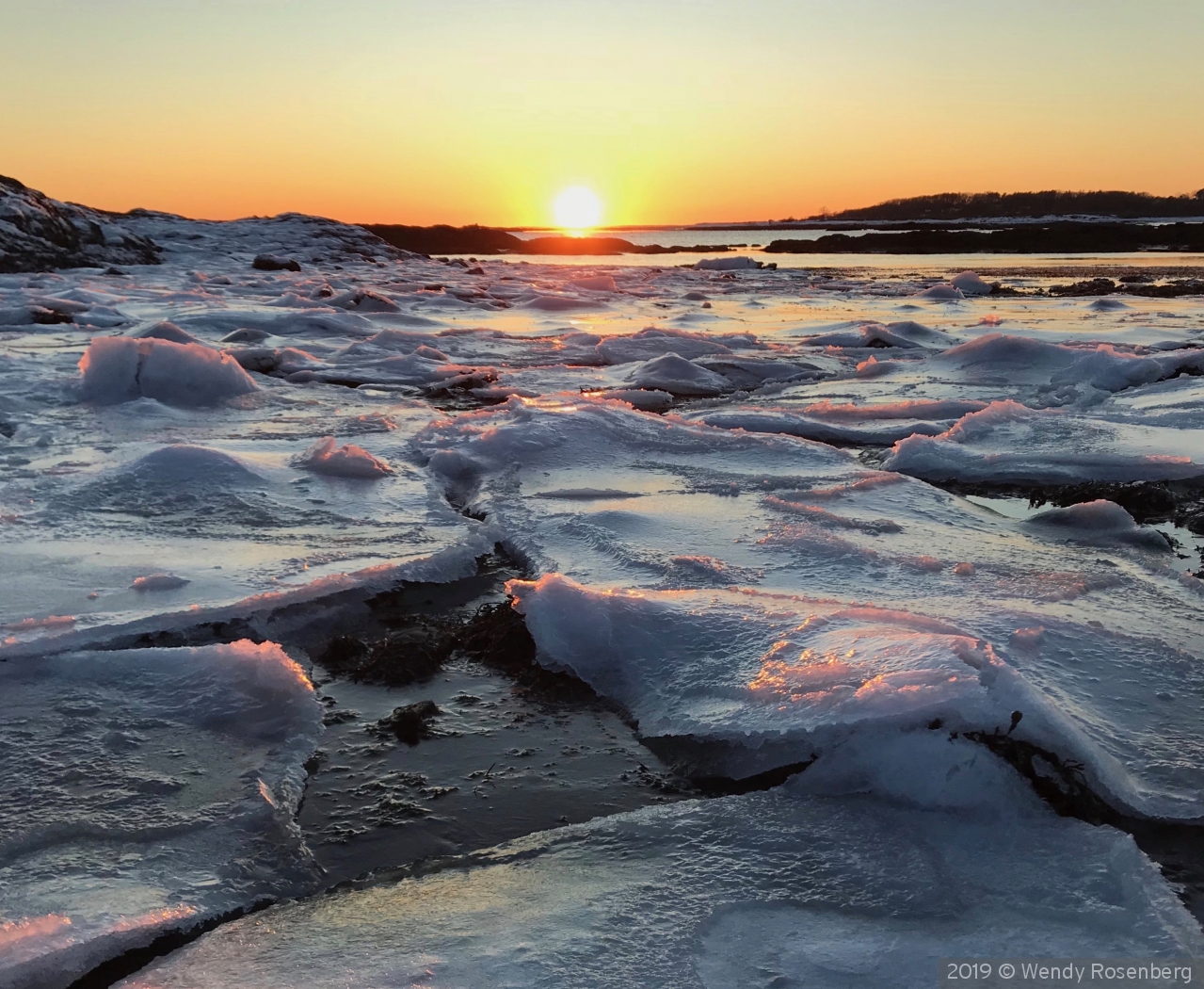 Winter sun over ice flows in Maine by Wendy Rosenberg