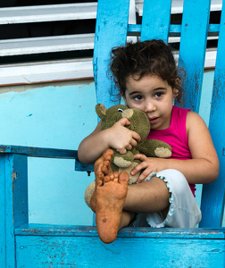 Cuban girl with toy - Photo by Nancy Schumann
