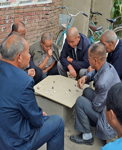 Deep Concentration During A Neighborhood Chinese Game - Photo by Louis Arthur Norton