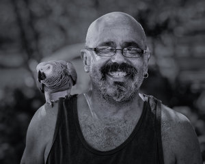 Man with Gray Parrot - Photo by John McGarry