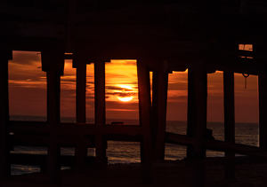 Sunrise under the pier - Photo by Richard Provost