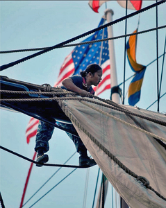 USS Constitution Sailor Aloft Bending On Sail - Photo by Louis Arthur Norton